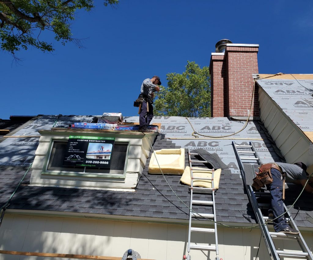 2 roofers inspecting for roof maintenance